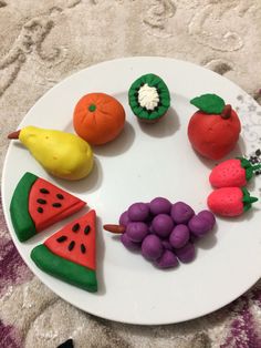 a white plate topped with fruits and vegetables