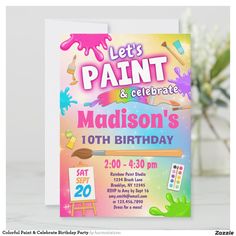 a birthday card with an image of paint and crayons on the front, next to a potted plant