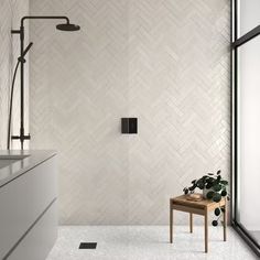 a bathroom with white tile walls and flooring next to a walk in shower stall