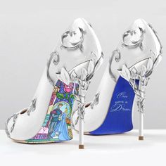 a pair of high heeled shoes with disney characters painted on the side and blue soles