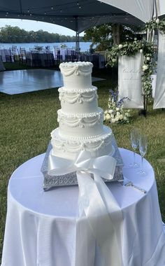 a white wedding cake sitting on top of a table