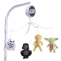 three star wars stuffed animals hanging from a lamp