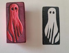 two rubber stamps with an image of a squid and a ghost on them are shown