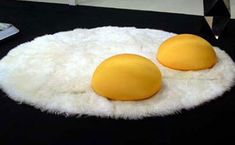 two eggs sitting on top of a white rug