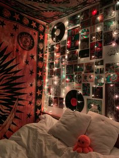 a bedroom decorated with lights and pictures on the wall