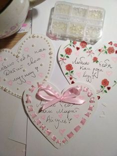 two heart shaped cards with writing on them