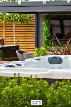 Transform your garden into a luxurious retreat with a custom-designed hot tub area. Surrounded by lush greenery, modern seating, and elegant privacy panels, this outdoor haven is perfect for unwinding or entertaining. Let The Garden Design Co. bring your vision to life. Book a consultation today! #gardendesign #moderngarden #luxurygarden #gardenideas #gardeninspiration #garden