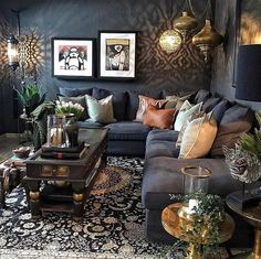 a living room filled with furniture and pictures on the wall next to a coffee table