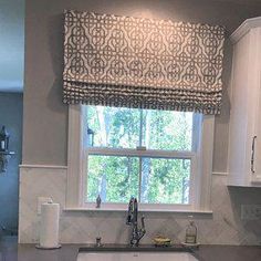 a kitchen with a sink and window in it