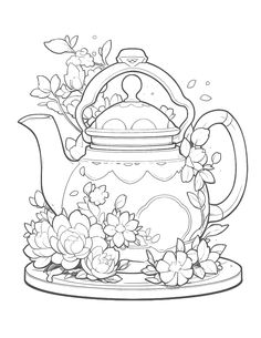 a teapot filled with flowers on top of a plate