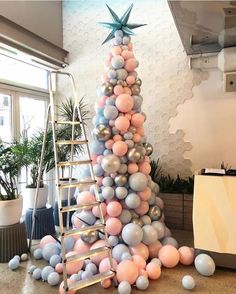 a tall christmas tree made out of balloons