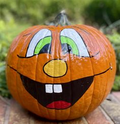 a pumpkin with an angry face painted on it