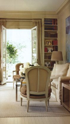 a living room filled with furniture and a book shelf