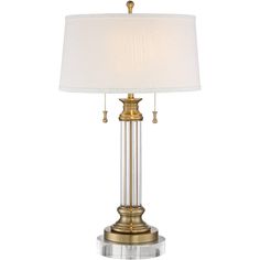 a table lamp with a white shade on the top and gold trimming around it