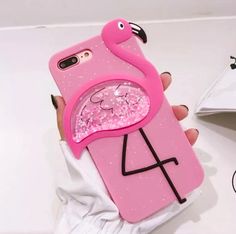 a person holding a pink phone case with a flamingo design on the front and back