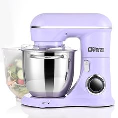 a purple kitchen mixer sitting next to a bowl with food in it on a white surface