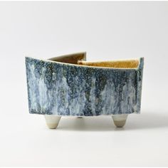 a blue and white planter sitting on top of a table