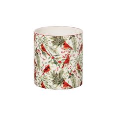 a white cup with red birds and holly branches on the inside, in front of a white background