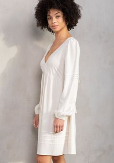 Designed in a lightweight linen blend, this retro-inspired mini dress is an instant bohemian classic. Featuring long voluminous sleeves, an adjustable tie-back detail, and delicate pintuck details. An effortless style that pairs well with a simple leather sandal. Linen blend Relaxed fit Long voluminous sleeve Elastic wrist cuff Mini length V-neckline Adjustable tie-back detail Half elastic waist at the back Empire waist Pintuck details Classic bohemian mini dress Model is 5'9, wearing a size S.S Solid Mini Dress With Balloon Sleeves For Spring, Elegant Puff Sleeve Dress With Blouson Sleeves For Spring, Chic Solid Color Puff Sleeve Dress For Brunch, Elegant Mini Dress With Blouson Sleeves For Brunch, Spring Daywear Puff Sleeve Dress With Bishop Sleeves, Chic Mini Dress With Gathered Bishop Sleeves, Spring Midi-length Puff Sleeve Dress With Blouson Sleeves, Chic Summer Midi Dress With Blouson Sleeves, Chic Spring Midi Dress With Blouson Sleeves