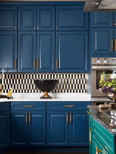 a kitchen with blue cabinets and white counter tops