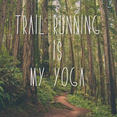 a trail running is my yoga with the words on it in white overlaying trees