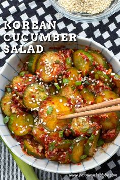 korean cucumber salad in a bowl with chopsticks and sesame seeds on the side