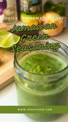 a jar filled with green liquid next to sliced limes