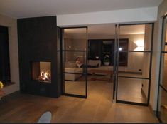 a living room filled with furniture and a fire place in the middle of the room