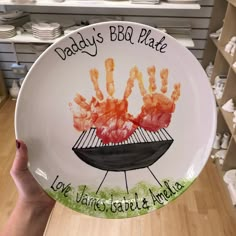 a person holding up a plate with shrimp on it that says daddy's bbq platter