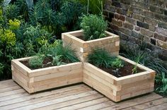 three wooden planters sitting on top of a wooden deck