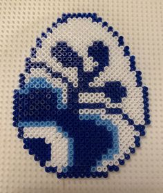 a blue and white beaded ornament with an image of a cartoon character