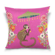 a pink pillow with a monkey holding an umbrella