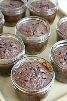 several jars filled with brownies sitting on top of a counter