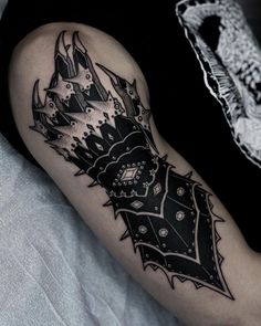 a black and white tattoo design on the arm