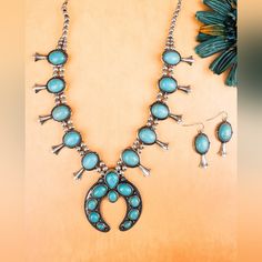 This Bold Necklace Set Will Add Western Flair To Any Outfit! 27" Long With 3" Extension Beaded Necklace Burnished Silvertone 2.5" Naja 1.5" Squash Blossoms Faux Turquoise Stone Beads Lobster Claw Closure 2" Fish Hook Style Earrings With 1.5" Drop Lead Compliant Western Style Turquoise Dangle Jewelry, Blue Teardrop Western Style Jewelry, Nickel-free Turquoise Western Jewelry, Western Style Nickel Free Turquoise Jewelry, Southwestern Blue Jewelry For Western-themed Events, Turquoise Necklace For Western-themed Events, Western Blue Jewelry For Western-themed Events, Squash Blossoms, Bold Necklace