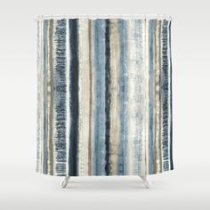 a shower curtain with blue and beige stripes on it, in front of a white background