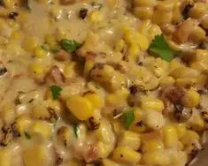 a pan filled with corn covered in cheese