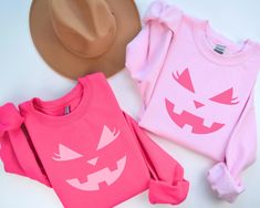 Embrace a girly Halloween theme with our Pink Halloween Pumpkin Sweatshirt! This adorable pumpkin crewneck features a cute pink jack-o-lantern face with eyelashes, making it perfect for adding a touch of whimsy to your fall wardrobe. Ideal for fans of pink Halloween decor, this cute fall sweatshirt combines comfort and style effortlessly. Whether you're decorating for the season or looking for a cozy outfit, our Halloween crewneck sweater is a must-have. Celebrate the spooky season in style with Pink Crew Neck Sweatshirt For Halloween, Pink Long Sleeve Halloween Sweatshirt, Pink Long Sleeve Sweatshirt For Halloween, Pumpkin Crewneck, Pink Halloween Decor, Girly Halloween, Pumpkin Outfit, Pumpkin Sweatshirt, Halloween Crewneck