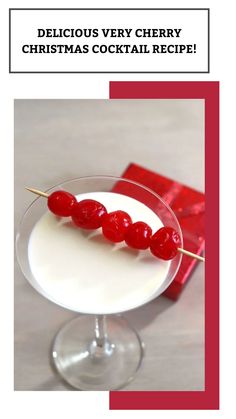 a christmas cocktail with cherries on a stick