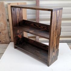 a wooden shelf sitting on top of a white table