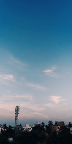 an airplane is flying in the sky over some buildings