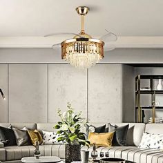 a living room filled with lots of furniture and a chandelier hanging from the ceiling