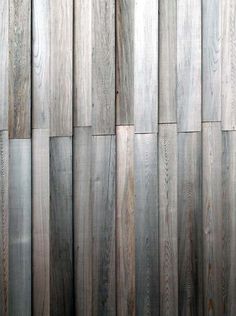 wood panels are arranged in rows on the wall