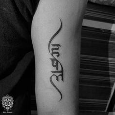 a man with a tattoo on his arm that says,'love'in cursive writing