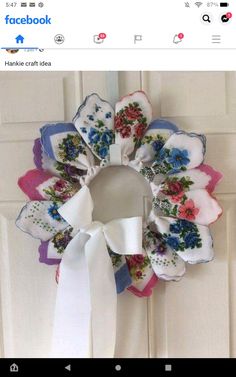 a white door with a wreath made out of cloths and flowers on it's side