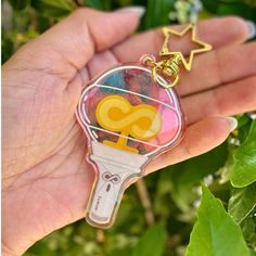 a hand holding a keychain with an air dry eraser in it