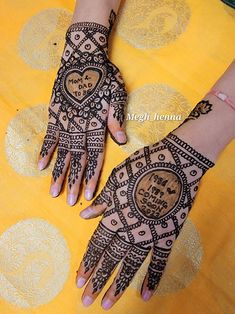 two hands with henna tattoos on them