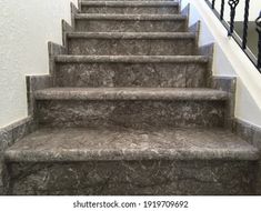 a set of stairs with marble steps leading up to the second floor in a house