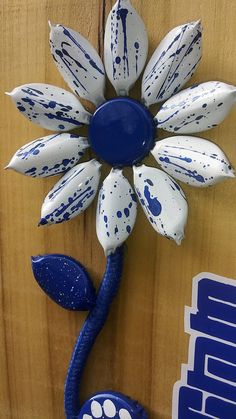 a blue and white flower on the side of a wooden door