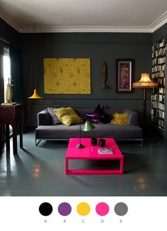 a living room filled with furniture and lots of books on the wall above it is a pink coffee table